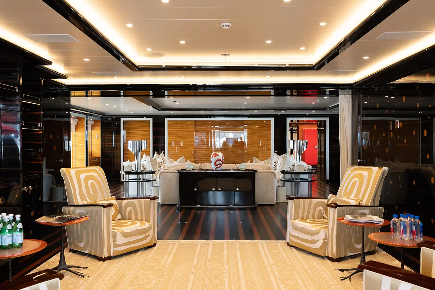 ALFA NERO main salon with Alberto Pinto wave-pattern armchairs and ebony joinery
