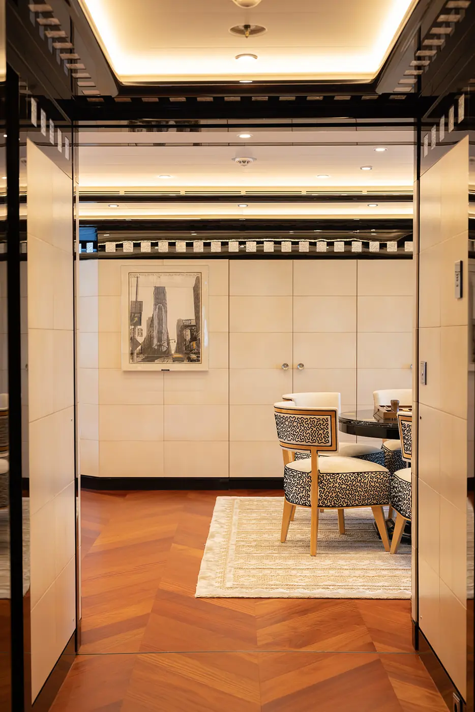 ALFA NERO dining room entry with chevron floor, Chagall print and patterned chairs