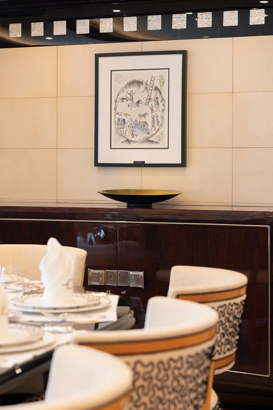 Chagall lithograph above ebony sideboard in ALFA NERO dining room