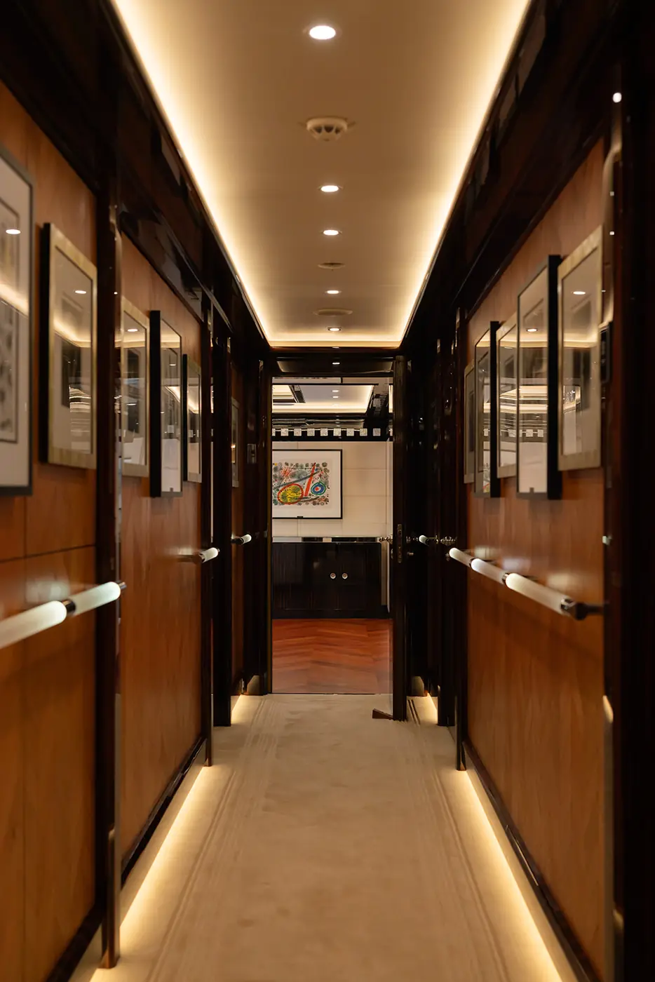ALFA NERO guest cabin corridor with framed art and warm lighting